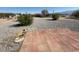 Wide open backyard featuring a patio, desert landscaping, and multiple outbuildings at 4330 Turner Blvd, Pahrump, NV 89061