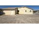 Exterior of a single-story home featuring a side door, dark-framed windows, and gravel landscaping at 4330 Turner Blvd, Pahrump, NV 89061