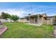Lush backyard featuring a covered patio and ample green space at 4428 Ash Ave, Las Vegas, NV 89110