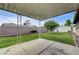 Well-maintained backyard with a covered patio and green lawn at 4428 Ash Ave, Las Vegas, NV 89110