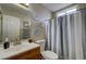 Bathroom featuring a wood vanity and a shower with a gray and white shower curtain at 4428 Ash Ave, Las Vegas, NV 89110