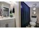 Bathroom featuring a single sink vanity and toilet with a blue patterned shower curtain at 4428 Ash Ave, Las Vegas, NV 89110