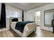 Bedroom featuring a comfortable bed with a blue blanket and ensuite bathroom at 4428 Ash Ave, Las Vegas, NV 89110