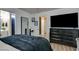 Bright bedroom featuring wood-look floors and furniture, plus ensuite bath access at 4428 Ash Ave, Las Vegas, NV 89110