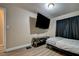 Bedroom featuring a large TV and a comfortable bed with black curtains at 4428 Ash Ave, Las Vegas, NV 89110