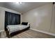 A neutral-toned bedroom featuring black curtains and minimalist decor at 4428 Ash Ave, Las Vegas, NV 89110