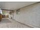A carport of the home, offering covered parking or storage space, with gravel and a wall of the house at 4428 Ash Ave, Las Vegas, NV 89110