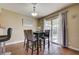 Cozy dining area featuring a modern table set and sliding glass doors to the backyard at 4428 Ash Ave, Las Vegas, NV 89110