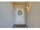 Close-up of the home's front door featuring a decorative wreath and exterior light fixture to enhance the entry at 4428 Ash Ave, Las Vegas, NV 89110