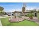 Landscaped front yard featuring desert landscaping, a brick planter and green turf, adding to the home's curb appeal at 4428 Ash Ave, Las Vegas, NV 89110