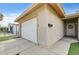 Attached garage with a white door, complemented by a decorative wreath on the front door of the home at 4428 Ash Ave, Las Vegas, NV 89110