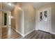 Foyer hallway featuring neutral colored walls, wood-look floors, and a patterned front door at 4428 Ash Ave, Las Vegas, NV 89110