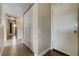 Hallway featuring neutral colored walls, wood-look floors, closet doors, and a front door at 4428 Ash Ave, Las Vegas, NV 89110