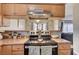 Close up on the kitchen featuring a black electric stove and light wood cabinetry at 4428 Ash Ave, Las Vegas, NV 89110