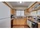 Well-lit kitchen offering wood cabinets, a double sink, and essential appliances at 4428 Ash Ave, Las Vegas, NV 89110