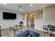 Living room with an accent wall, wood floors, recessed lighting and open access to other rooms at 4428 Ash Ave, Las Vegas, NV 89110
