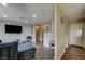 Open-concept living area with modern 3D accent wall and hardwood flooring throughout at 4428 Ash Ave, Las Vegas, NV 89110
