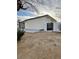 Spacious backyard includes gravel, mature vegetation, a small covered patio, and a gated fence at 5013 Vermont Ave, Las Vegas, NV 89107