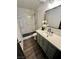 Updated bathroom with white marble tile shower, a vanity with modern sink, and updated lighting at 5013 Vermont Ave, Las Vegas, NV 89107