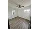 Cozy bedroom with hardwood floors, windows, and ceiling fan at 5013 Vermont Ave, Las Vegas, NV 89107