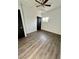 Bright bedroom features light gray flooring, a ceiling fan, and a double-door closet at 5013 Vermont Ave, Las Vegas, NV 89107