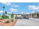 Side view featuring a long driveway, desert landscaping, and exterior privacy gate at 5013 Vermont Ave, Las Vegas, NV 89107