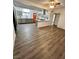 Open living room showing hardwood floors, lots of light and views into the modern kitchen at 5013 Vermont Ave, Las Vegas, NV 89107