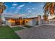 A backyard has an outdoor dining area with string lights, gravel and artificial turf at 5208 Overland Ave, Las Vegas, NV 89107