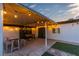 This backyard covered patio has string lights, outdoor seating, and a foosball table at 5208 Overland Ave, Las Vegas, NV 89107