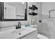 Bathroom featuring a sink vanity and tiled walk-in shower with storage at 5208 Overland Ave, Las Vegas, NV 89107