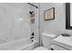 Updated bathroom features modern bathtub, shower, toilet, and vanity at 5208 Overland Ave, Las Vegas, NV 89107
