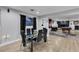 Elegant dining area with modern chairs, a glass table, and an open view into the game room at 5208 Overland Ave, Las Vegas, NV 89107
