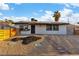 This home features a desert landscaped yard, solar panels and a wooden fence at 5208 Overland Ave, Las Vegas, NV 89107