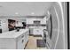 Stylish kitchen featuring stainless steel appliances, a quartz countertop island, and plenty of storage at 5208 Overland Ave, Las Vegas, NV 89107