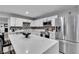 Well-equipped kitchen with white cabinets, stainless steel appliances, and a large center island with seating at 5208 Overland Ave, Las Vegas, NV 89107