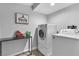 Bright laundry area features modern washer, dryer, and countertop for folding at 5208 Overland Ave, Las Vegas, NV 89107