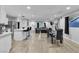 Bright, open-concept living space with a large island, stainless steel appliances, and a dining area at 5208 Overland Ave, Las Vegas, NV 89107