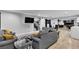 Spacious living room with modern decor, comfortable seating, and access to a game room at 5208 Overland Ave, Las Vegas, NV 89107