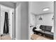 Hallway sitting area with black futon, wall art, and access to a bathroom at 5208 Overland Ave, Las Vegas, NV 89107