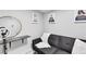 Close-up of hallway sitting area with black futon and decorative wall art at 5208 Overland Ave, Las Vegas, NV 89107