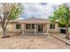 A well maintained backyard with covered patio, desert landscaping, and mature trees at 5319 Farley Feather Ct, North Las Vegas, NV 89031