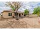 Large backyard with desert landscaping, covered patio, and mature trees at 5319 Farley Feather Ct, North Las Vegas, NV 89031