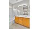 Bathroom featuring a shower-over-tub and double sink vanity with wood cabinets at 5319 Farley Feather Ct, North Las Vegas, NV 89031