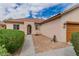 Charming home exterior featuring a stucco facade, tiled roof, and drought-tolerant landscaping at 5319 Farley Feather Ct, North Las Vegas, NV 89031