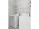 Efficient laundry area with a washer, dryer, and convenient shelving at 5319 Farley Feather Ct, North Las Vegas, NV 89031
