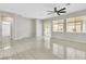 Sunlit living room featuring tile floors, a ceiling fan, and access to the backyard at 5319 Farley Feather Ct, North Las Vegas, NV 89031