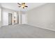 Large primary bedroom with carpet, ceiling fan, and adjoining bathroom and closet at 5319 Farley Feather Ct, North Las Vegas, NV 89031