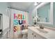Bathroom featuring a white vanity with a decorative shower curtain with a 'Hello Sunshine' theme at 5853 Gentleslope St, Henderson, NV 89011