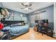 Blue bedroom featuring a bunk bed and desk by the window with a ceiling fan and wood floors at 5853 Gentleslope St, Henderson, NV 89011