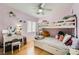 Bright bedroom with bunk beds, light wood floors, shelves and vanity with decorative mirror and stool at 5853 Gentleslope St, Henderson, NV 89011